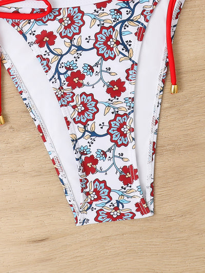 Women's one-shoulder bikini with red and blue floral print on white, featuring red trim and tie-side bottoms. - Image 14