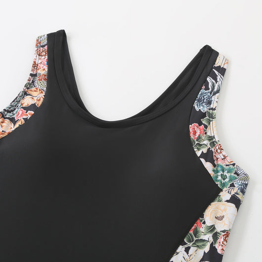 Black one-piece women's swimsuit with colorful floral side panels and boy shorts style bottom. - Image 11