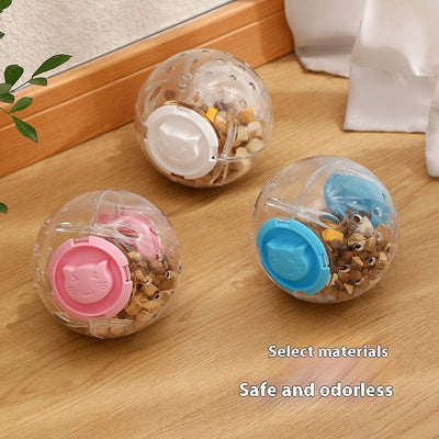 Clear plastic pet tumbler food leakage toy with blue accents and a cat face design, on a wooden floor. - Image 2
