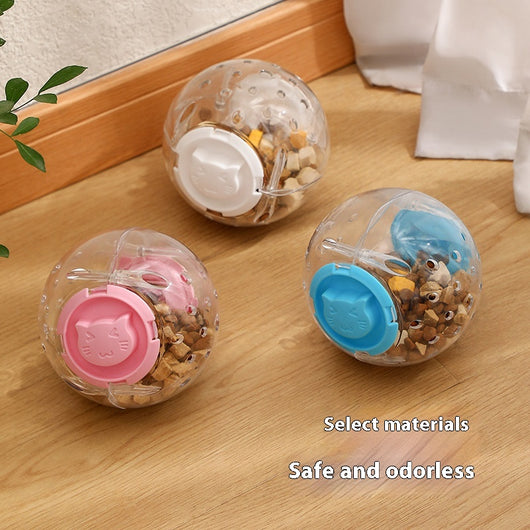 Clear plastic pet tumbler food leakage toy with blue accents and a cat face design, on a wooden floor. - Image 2