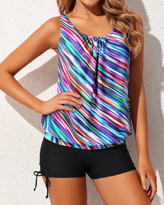 Women's two-piece tankini swimsuit with a colorful abstract print tank top and solid black ruched swim shorts. - Image 5