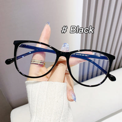 Black full-frame round anti-blue light glasses held by a hand with a gold ring and light blue gradient nails. - Image 6