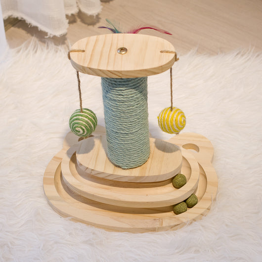 White cat playing with a wooden multi-level track toy featuring a spring-mounted yellow feather ball and a green catnip ball. - Image 14