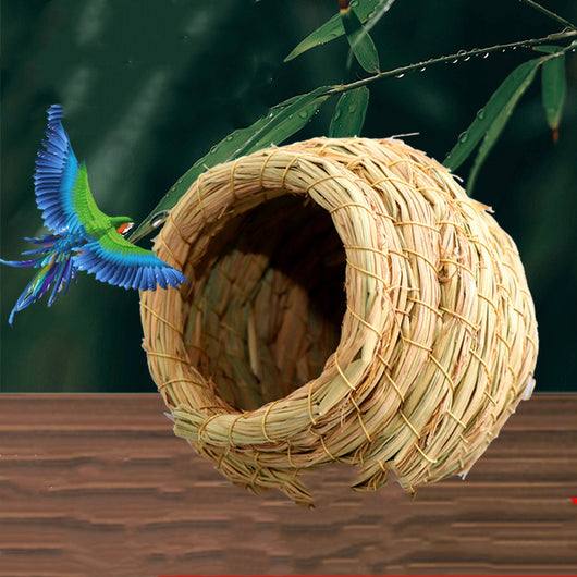 Hand-woven straw bird nest with a round entrance, designed for small birds and pets, shown with a colorful bird flying towards it. - Image 8