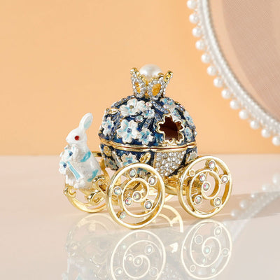 White and gold princess carriage trinket box with a crown, pearl, and bunny figurine, adorned with rhinestones.