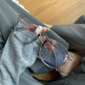 Retro square transparent full-frame glasses with blue light lenses, held by a person wearing grey sweatpants. - Image 17