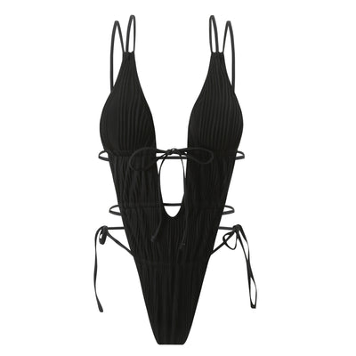 Woman in a light yellow ribbed one-piece tie-front backless bikini relaxing on a sandy beach by the ocean. - Image 17