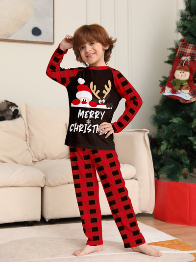 Family of four wearing matching red and black buffalo plaid Christmas pajamas with reindeer graphic. - Image 2