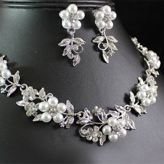 Silver-tone bridal necklace and earring set with white pearls and clear rhinestones in a floral leaf design.