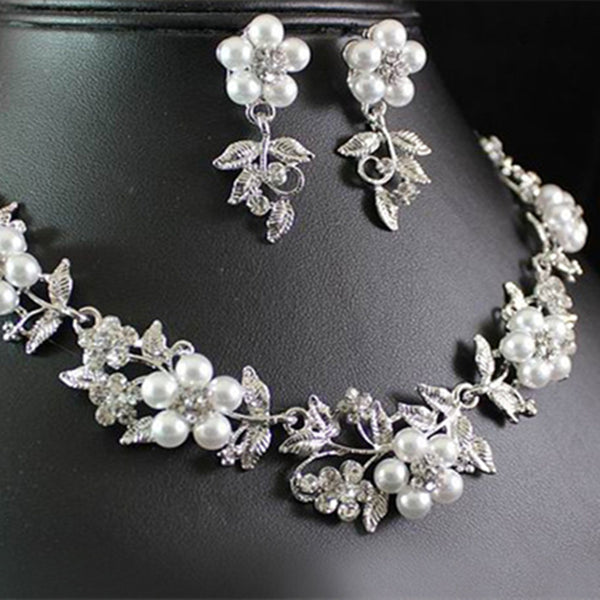 Silver-tone bridal necklace and earring set with white pearls and clear rhinestones in a floral leaf design.