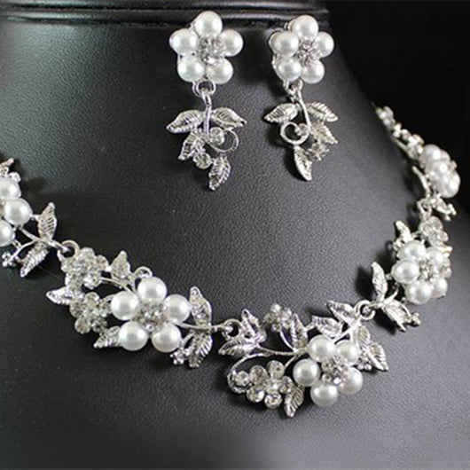 Silver-tone bridal necklace and earring set with white pearls and clear rhinestones in a floral leaf design.