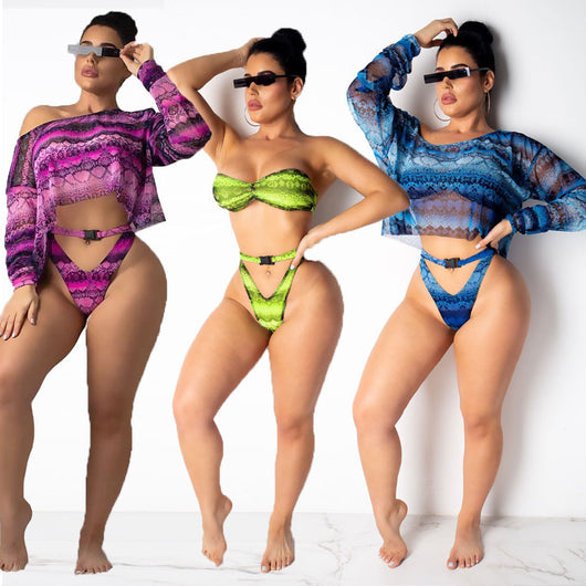 Woman in a purple and pink snakeskin print three-piece swimsuit with an off-shoulder crop top and high-waisted bottoms. - Image 2
