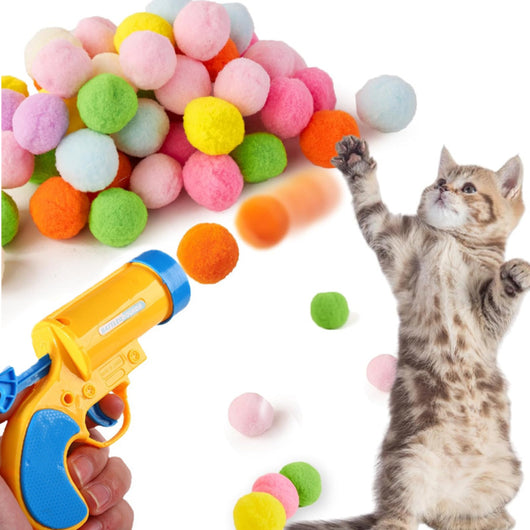 Pink pompom firing gun with a pile of colorful pompom balls and a cat playing with an orange ball. - Image 16