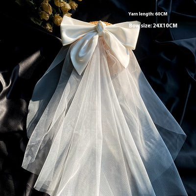 White birdcage veil with a cream satin bow and faux pearls, attached to a woven straw base, 80cm yarn length. - Image 10