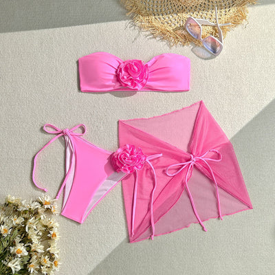 Women's blue tube top swimsuit with a large 3D flower, tie-side bikini bottoms, and a sheer sarong skirt. - Image 6