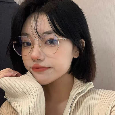 Rose gold frameless polygon anti-blue light glasses with clear lenses, held by a hand with pink nails. - Image 12