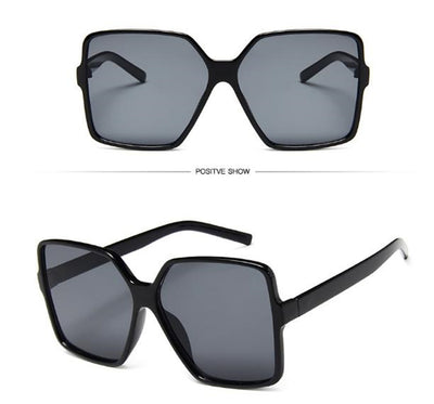 Oversized square sunglasses with a black and tortoiseshell frame and gradient purple lenses, shown from two angles. - Image 2