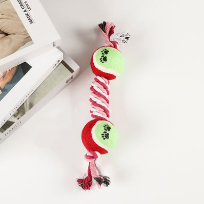 Red, pink, and white braided cotton rope dog toy with a green and red tennis ball featuring black paw prints. - Image 4