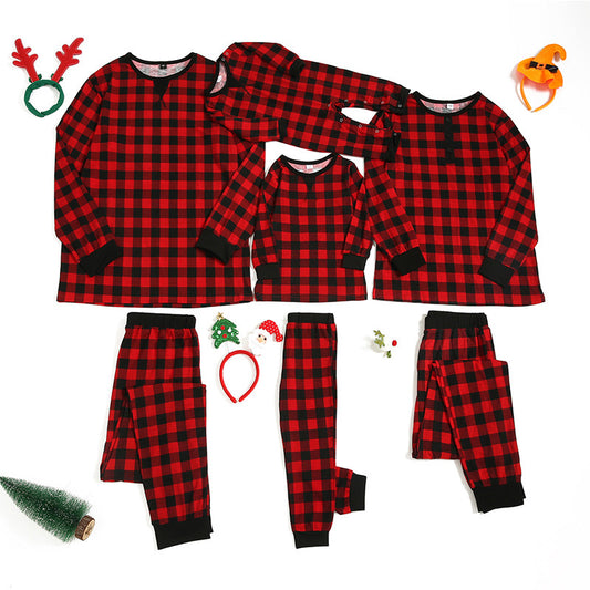 Red and black plaid long-sleeve family pajamas, including adult, child, and baby sizes, with festive accessories.