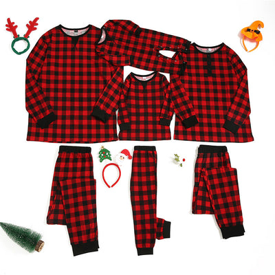 Red and black plaid long-sleeve family pajamas, including adult, child, and baby sizes, with festive accessories.