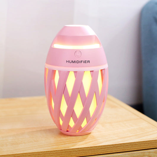 Light green football-shaped humidifier with a decorative lattice pattern and a power button on top. - Image 4