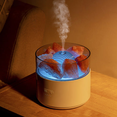 White cool-mist humidifier and aroma diffuser with glowing blue LED lights and orange crystal salt rocks, emitting mist. - Image 7