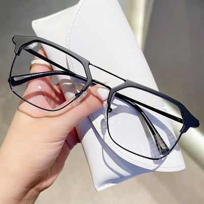 Anti-blue light glasses with a sand black and silver double beam frame, held against a white case. - Image 3