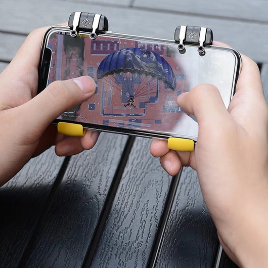 Black and silver mobile gaming trigger controller attached to a silver smartphone, showing the left button and game screen. - Image 4