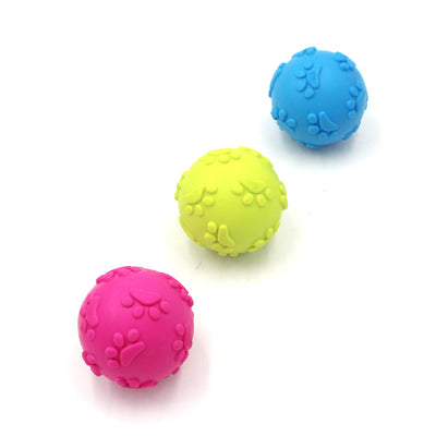 Bright pink TPR dog toy ball with raised paw print and oval patterns, designed for chewing and play. - Image 2