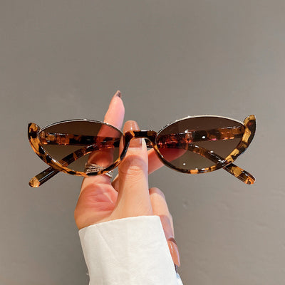 Pink cat-eye sunglasses with purple gradient lenses on a white background, showcasing a trendy style. - Image 13
