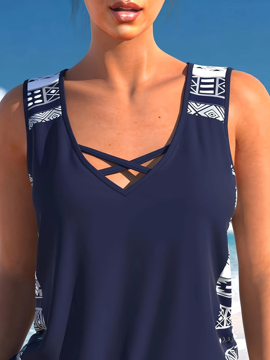Women's navy blue tankini swimsuit with geometric pattern, criss-cross V-neck, and matching swim shorts. - Image 13