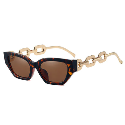 Red cat-eye sunglasses with dark lenses and gold-colored chain link temples on a white background. - Image 4