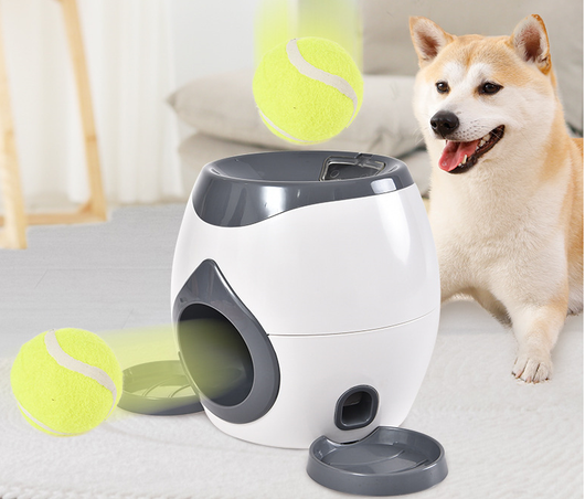 Smart pet feeder and tennis ball reward machine in white and lime green, with two mini tennis balls and a scoop. - Image 2