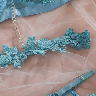 Light blue lace lingerie set with floral details, including a bra, thong, garter belt, choker, and leg chains. - Image 6