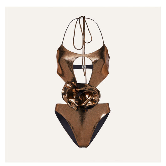 Metallic bronze one-piece swimsuit with a one-shoulder design, large decorative flower, and side cut-out revealing a black panel. - Image 5