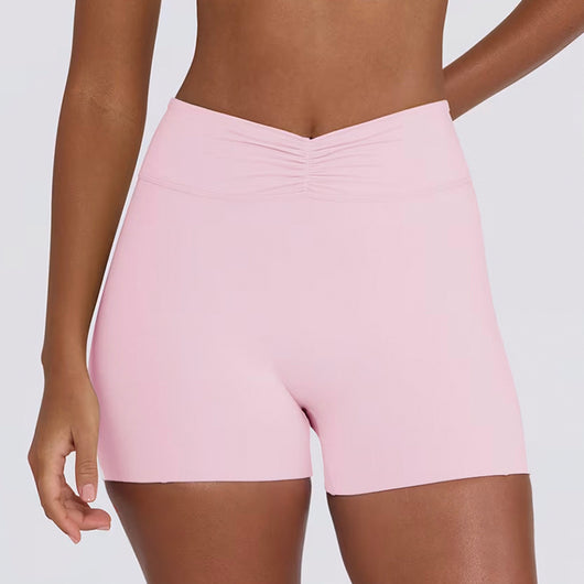 Light pink halter neck sports bra and high-waisted leggings workout set on a model. - Image 26