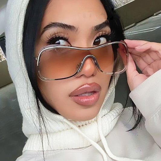 Women's fashionable shield sunglasses with a gold metal frame and dark gray lenses, featuring a unique wavy design. - Image 2