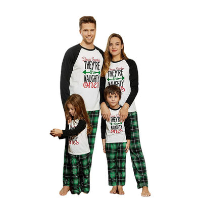 Family of four in matching Christmas pajamas with 'Dear Santa THEY'RE the NAUGHTY ones' graphic and green plaid pants. - Image 4
