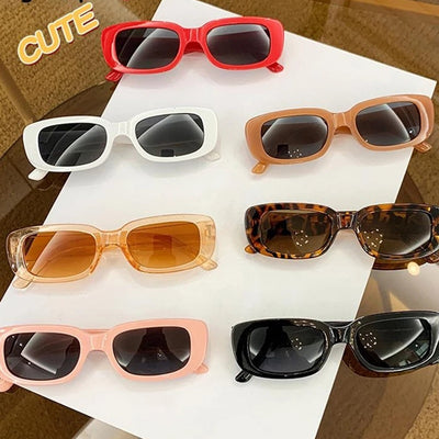 Children's small frame oval sunglasses with a solid white PC frame and brown AC lenses for UV protection. - Image 23