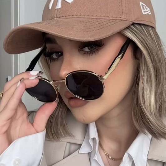 Silver metal round frame sunglasses with dark grey lenses and black temples, offering UV protection for women.