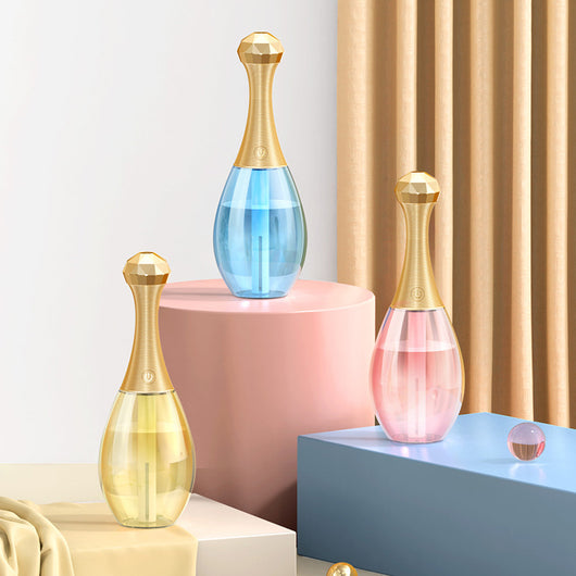 Mini silent portable humidifier shaped like a perfume bottle, with a clear body and a gold ribbed neck and faceted cap. - Image 12
