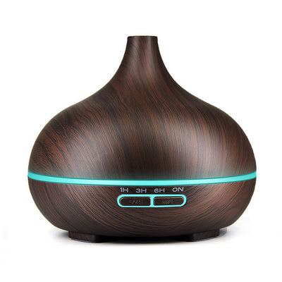 Wood grain ultrasonic aromatherapy diffuser and humidifier with a glowing blue LED light band and control buttons.