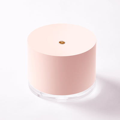 Pink cylindrical mini wireless humidifier with a clear base and a small gold mist outlet on top. - Image 5