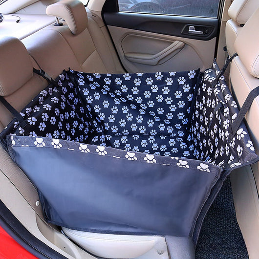 Brown pet car mat with colorful dog pattern installed in a car's rear seat, protecting upholstery. - Image 6