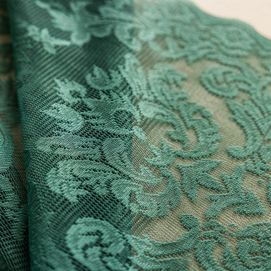 Close-up of a dark green lace curtain with an intricate floral and scrollwork pattern on sheer polyester fabric. - Image 2