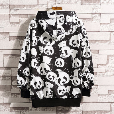 Mother and baby wearing matching black and white panda print pajamas, sitting together on a white bed. - Image 4