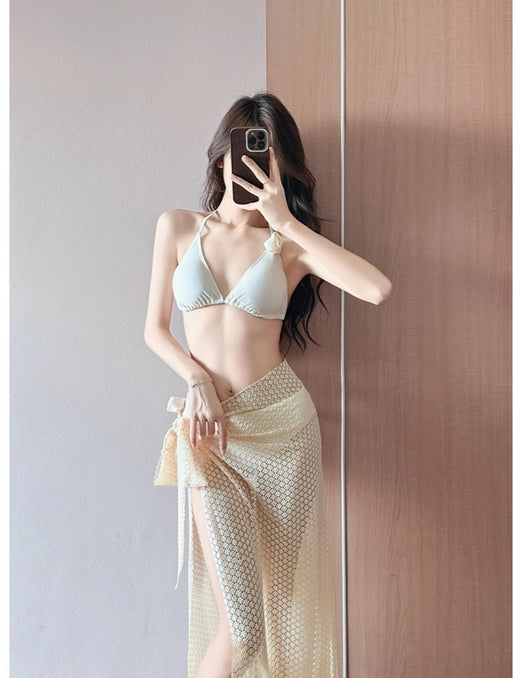 Women's light purple three-piece bikini set with a triangle halter top, bottoms, and a mesh sarong with rose details. - Image 11