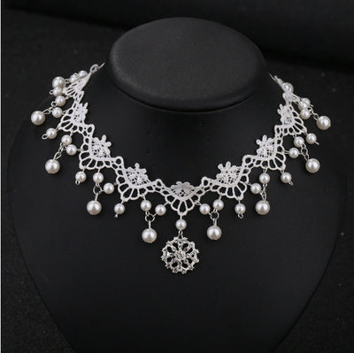 White lace choker necklace with dangling faux pearls and a central rhinestone pendant on a black jewelry bust. - Image 9
