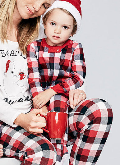 Mother and child in matching red, black, and white plaid Christmas pajamas, child wearing a Santa hat. - Image 13