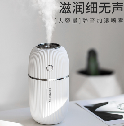 Pink mini ultrasonic air humidifier with ribbed texture and rose gold accents, emitting a fine mist on a white shelf. - Image 5